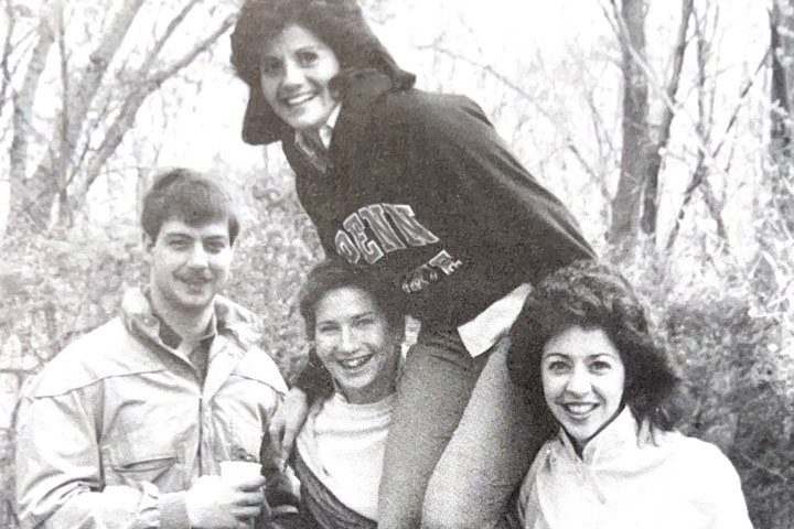 Four students gathered outside in 1984