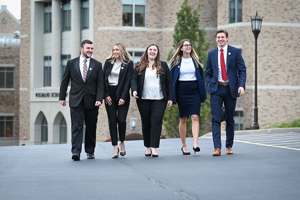 Five interns in business professional attire.