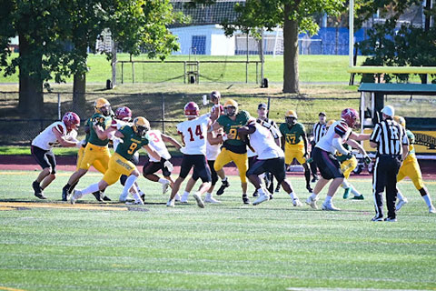 The Cardinal football team runs a play against SUNY Brockport.