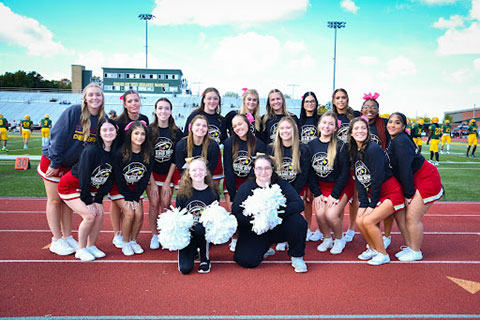 Fisher cheerleaders pose with their two honorary cheerleaders.