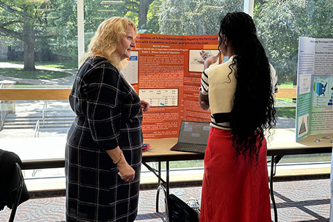 Ed.D. students share their research with guests at the Poster Presentation session.