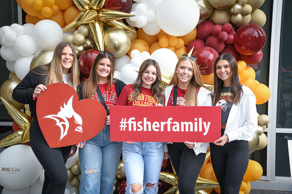 A group of Fisher graduates take a picture at the photo booth during Alumni Weekend 2023.