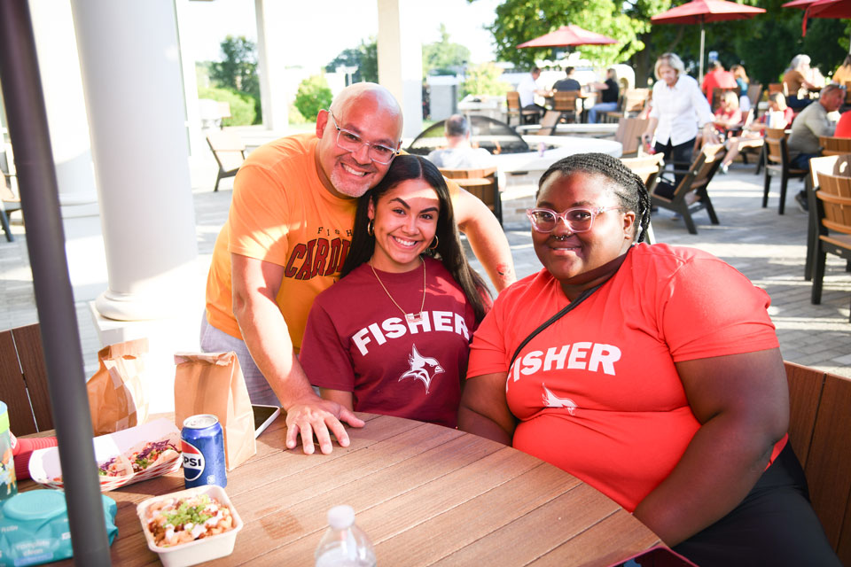 Three members of the Fisher community enjoy a meal during Family Weekend.