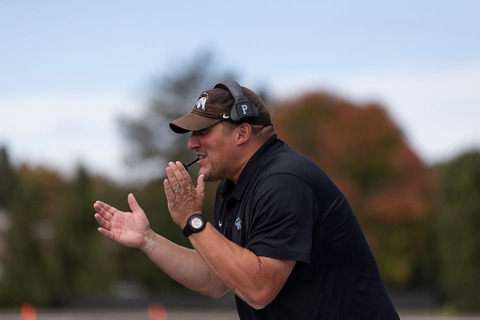 Ed Raby, Jr. claps during a game.