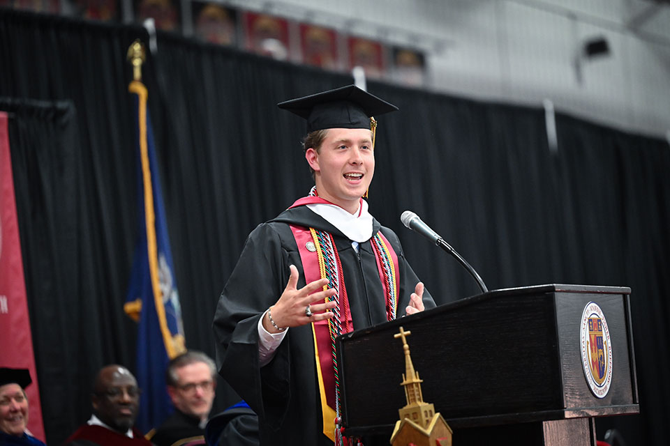 Ian Klenk speaks at Commencement.