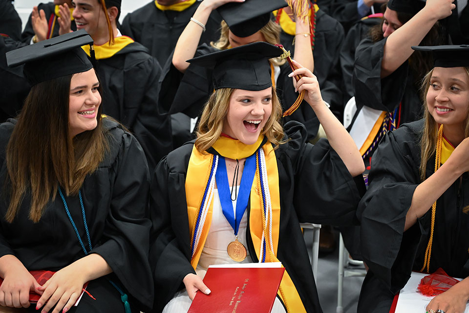 A 2024 graduate moves her tassel.