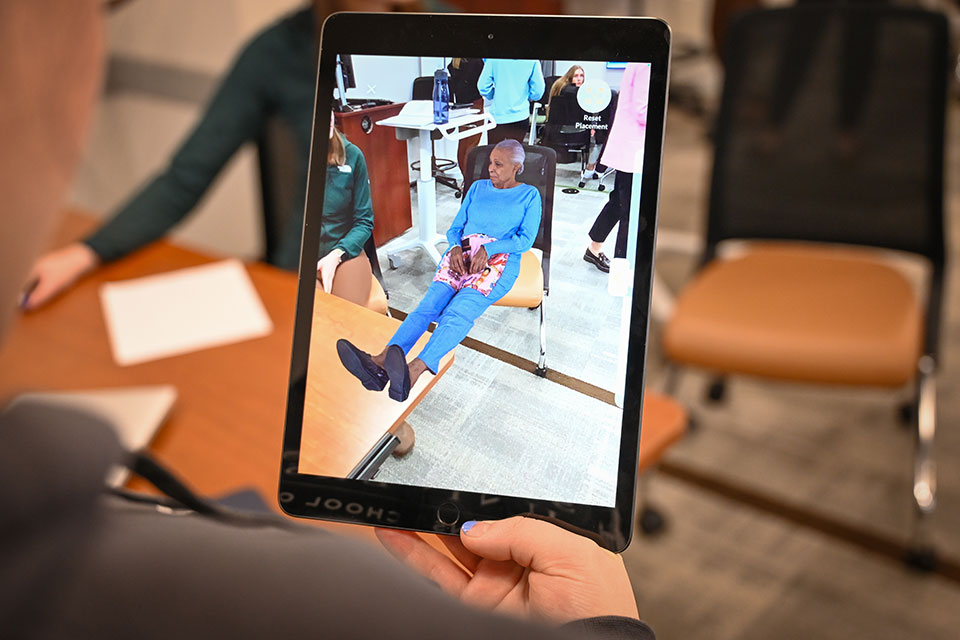 A student views a patient through augmented reality technology.