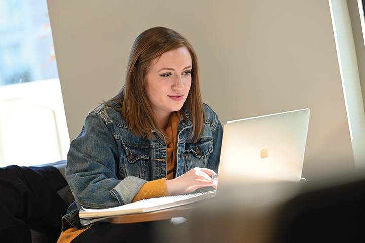 A student studies at a computer.