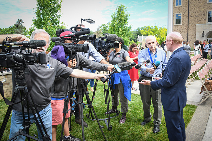 Media interviews President Rooney campus for the university announcement.