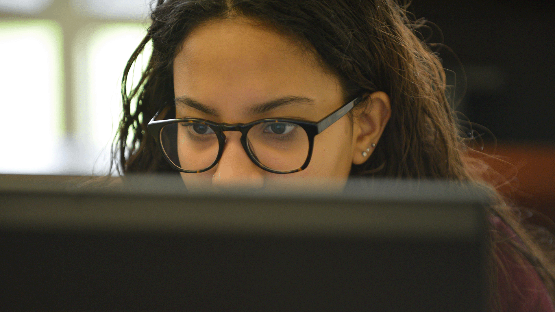 A student studies at a laptop.