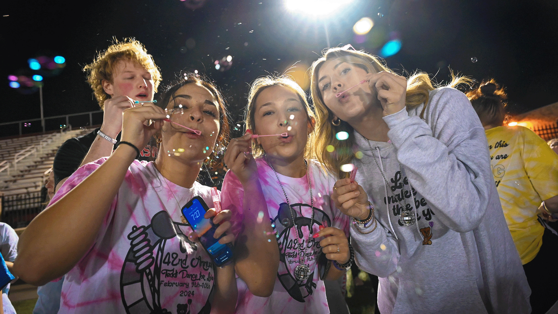 Students blowing bubbles at the Teddi Dance for Love.