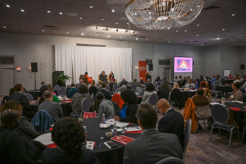 Several conference attendees participate in panel discussion about diversity in the workplace.
