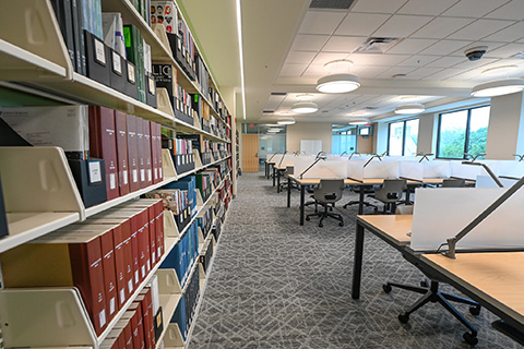 Student workspaces near a generous reference collection.