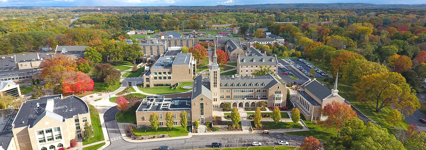 Aerial view of St. John Fisher University campus in fall with Kearney Hall prominent.