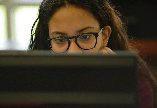 A student looks over a computer.